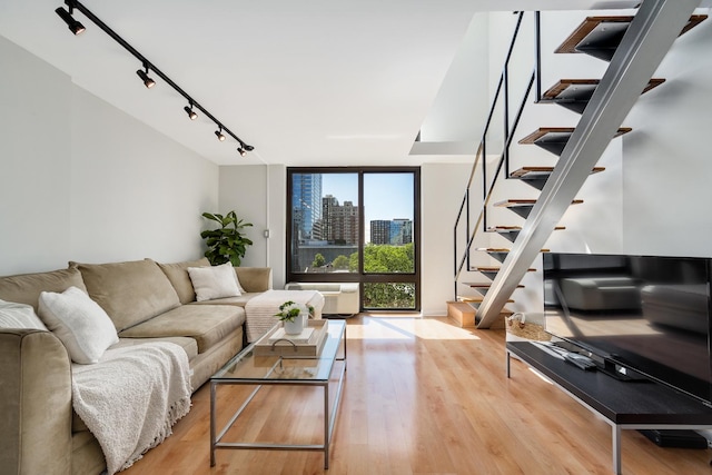 1221 N Dearborn St Unit 601S, Chicago, IL 60610 - living room featuring stairway, floor to ceiling windows, track lighting, and wood finished floors