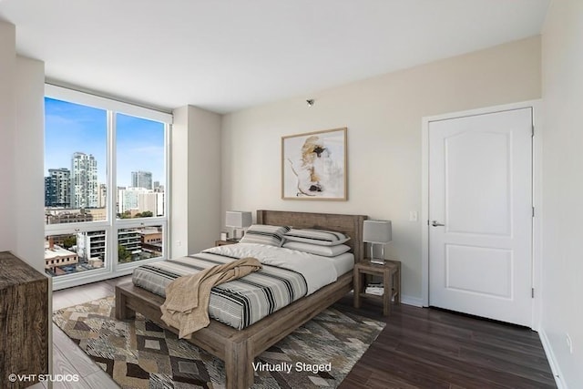 757 N Orleans St Unit 1509, Chicago, IL 60654 - bedroom with dark wood-type flooring, baseboards, and a city view