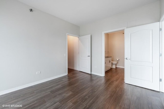 757 N Orleans St Unit 1509, Chicago, IL 60654 - unfurnished bedroom featuring dark wood finished floors, baseboards, and ensuite bathroom