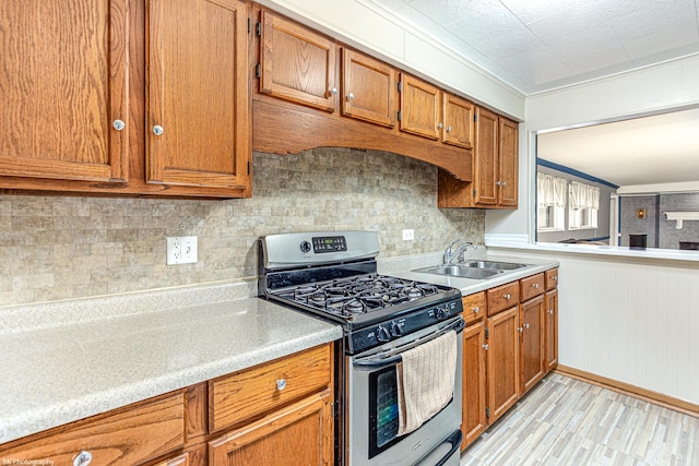 4243 W 90th Pl, Hometown, IL 60456 - kitchen featuring stainless steel range with gas cooktop, a sink, brown cabinetry, light countertops, and tasteful backsplash