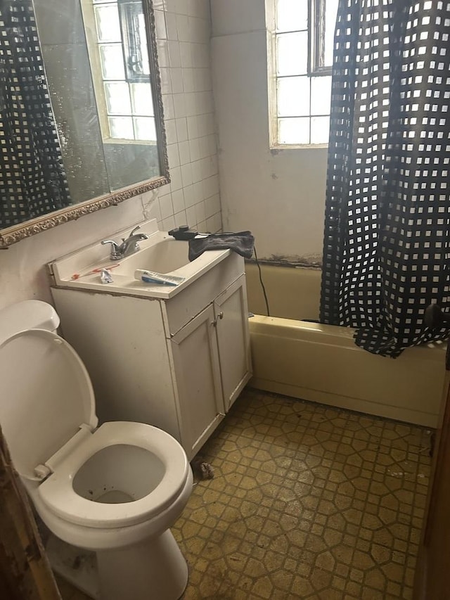 8039 S Ingleside Ave, Chicago, IL 60619 - bathroom with shower / tub combo, vanity, tile patterned floors, and tile walls