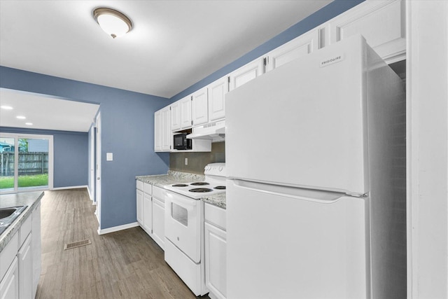 713 E Michigan Ave, Urbana, IL 61801 - kitchen featuring white appliances, under cabinet range hood, light countertops, wood finished floors, and white cabinetry