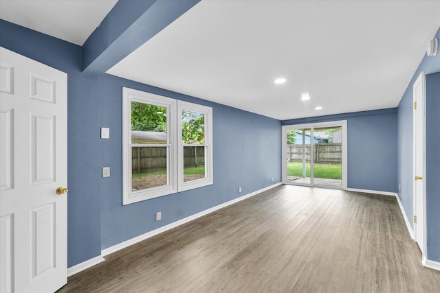 713 E Michigan Ave, Urbana, IL 61801 - empty room with baseboards, wood finished floors, healthy amount of natural light, and recessed lighting