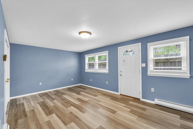 713 E Michigan Ave, Urbana, IL 61801 - entryway featuring healthy amount of natural light, wood finished floors, and a baseboard radiator