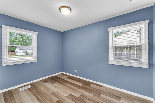 713 E Michigan Ave, Urbana, IL 61801 - spare room with wood finished floors and baseboards
