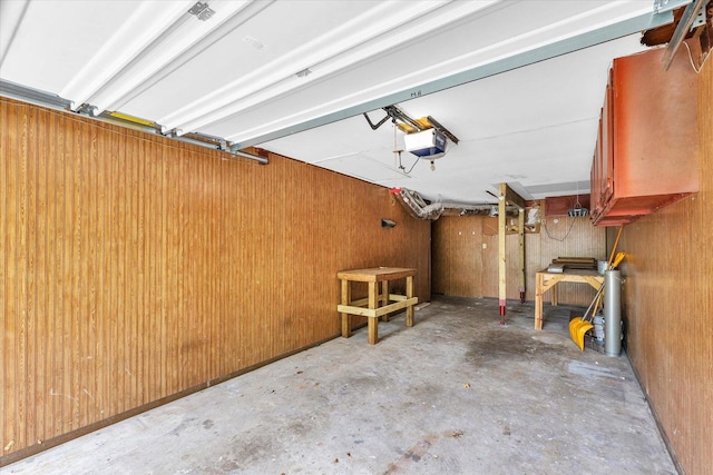 713 E Michigan Ave, Urbana, IL 61801 - garage featuring a garage door opener and wood walls