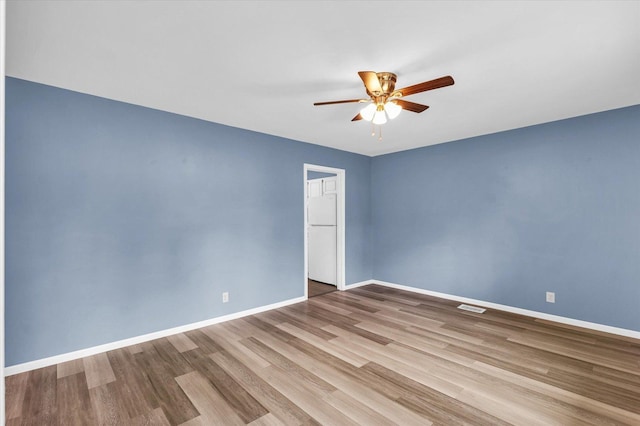 713 E Michigan Ave, Urbana, IL 61801 - unfurnished room featuring ceiling fan, wood finished floors, and baseboards