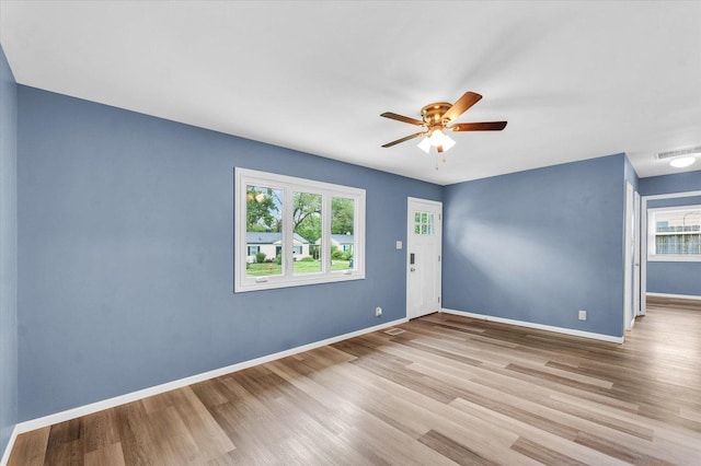 713 E Michigan Ave, Urbana, IL 61801 - spare room featuring plenty of natural light, wood finished floors, and baseboards