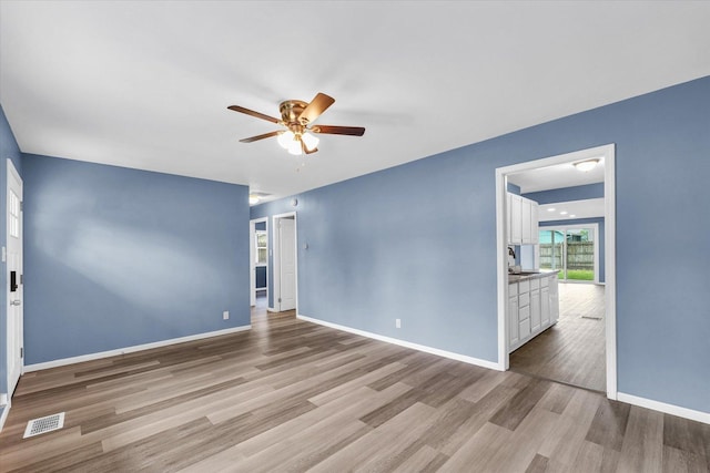 713 E Michigan Ave, Urbana, IL 61801 - spare room featuring ceiling fan, wood finished floors, and baseboards
