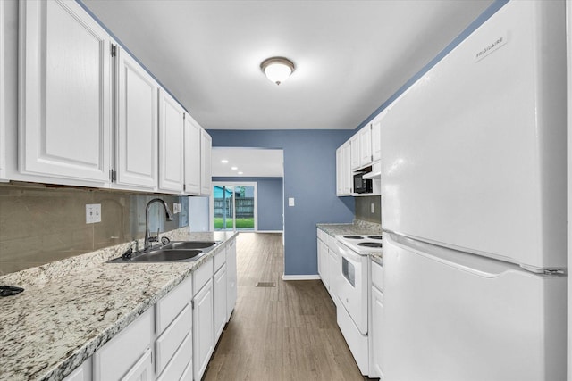 713 E Michigan Ave, Urbana, IL 61801 - kitchen with white appliances, a sink, wood finished floors, white cabinets, and decorative backsplash