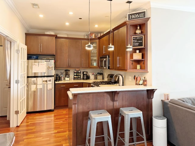 4950 N Western Ave Unit Ph2, Chicago, IL 60625 - kitchen featuring stainless steel appliances, ornamental molding, a peninsula, light wood-type flooring, and a breakfast bar