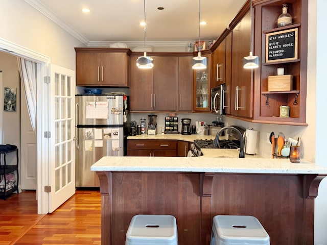 4950 N Western Ave Unit Ph2, Chicago, IL 60625 - kitchen with appliances with stainless steel finishes, a peninsula, open shelves, light wood-style floors, and ornamental molding