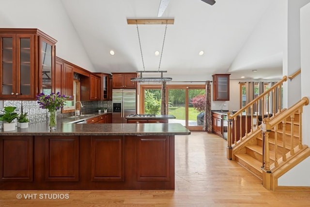 4335 Dewey Ave, Matteson, IL 60443 - kitchen with stainless steel refrigerator with ice dispenser, tasteful backsplash, a peninsula, light wood finished floors, and glass insert cabinets
