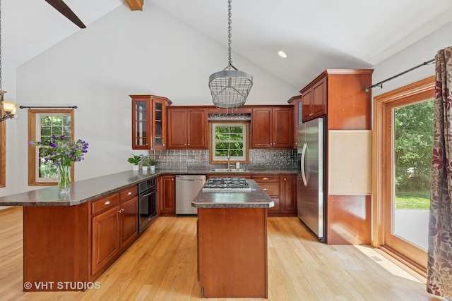 4335 Dewey Ave, Matteson, IL 60443 - kitchen with stainless steel appliances, a peninsula, dark countertops, light wood-type flooring, and high vaulted ceiling