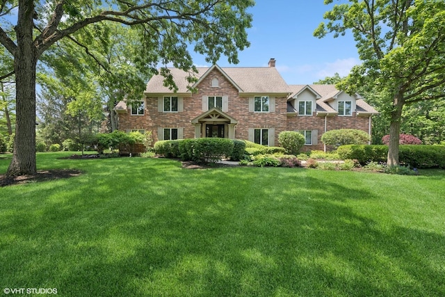 26874 N Countryside Lake Dr, Mundelein, IL 60060 - view of front of home featuring a chimney, a front yard, and brick siding