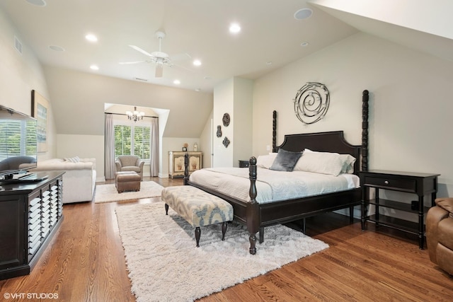 26874 N Countryside Lake Dr, Mundelein, IL 60060 - bedroom with vaulted ceiling, a chandelier, wood finished floors, a ceiling fan, and recessed lighting
