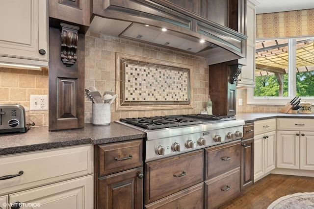 26874 N Countryside Lake Dr, Mundelein, IL 60060 - kitchen featuring stainless steel gas stovetop, decorative backsplash, custom range hood, and dark countertops