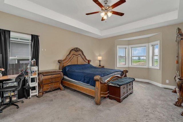 1200 Farmstone Dr, Diamond, IL 60416 - carpeted bedroom featuring baseboards, an office area, a tray ceiling, and ceiling fan
