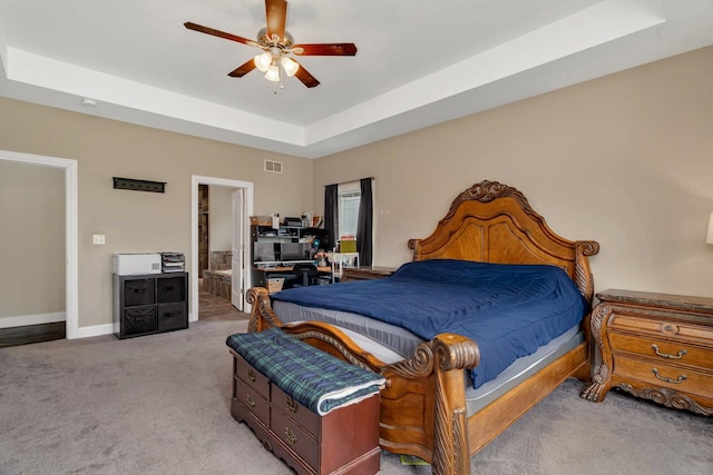 1200 Farmstone Dr, Diamond, IL 60416 - bedroom featuring a raised ceiling, light carpet, baseboards, connected bathroom, and a ceiling fan