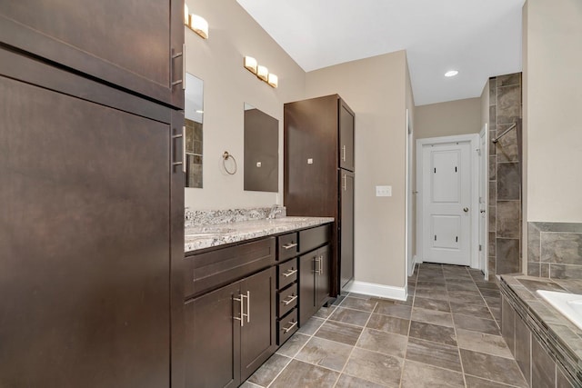 1200 Farmstone Dr, Diamond, IL 60416 - bathroom featuring tiled tub, double vanity, baseboards, and a tile shower