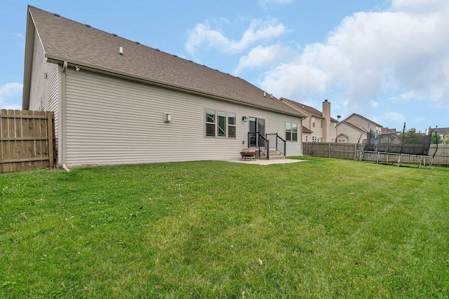 1200 Farmstone Dr, Diamond, IL 60416 - rear view of property with a trampoline, a patio area, and a shingled roof