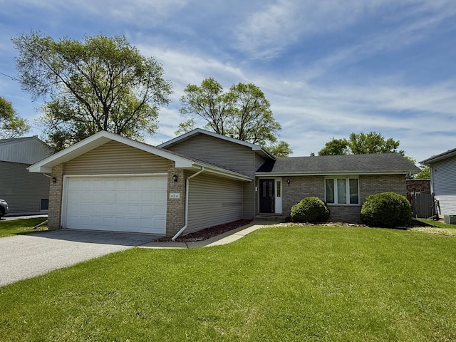 424 E Clark St, Glenwood, IL 60425 - view of front of property with brick siding, a garage, driveway, and a front yard