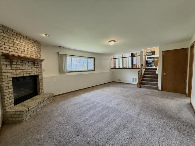 424 E Clark St, Glenwood, IL 60425 - unfurnished living room featuring a fireplace, stairway, carpet flooring, and baseboards