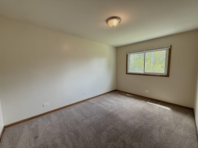 424 E Clark St, Glenwood, IL 60425 - carpeted empty room featuring baseboards