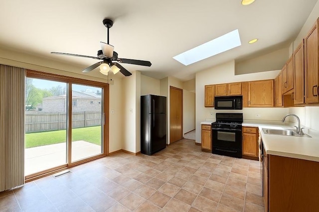 424 E Clark St, Glenwood, IL 60425 - kitchen featuring black appliances, a sink, a skylight, light countertops, and vaulted ceiling