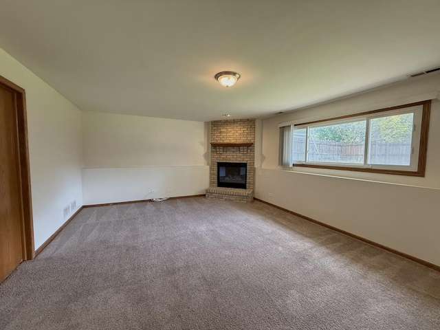 424 E Clark St, Glenwood, IL 60425 - unfurnished living room featuring baseboards, carpet flooring, and a brick fireplace