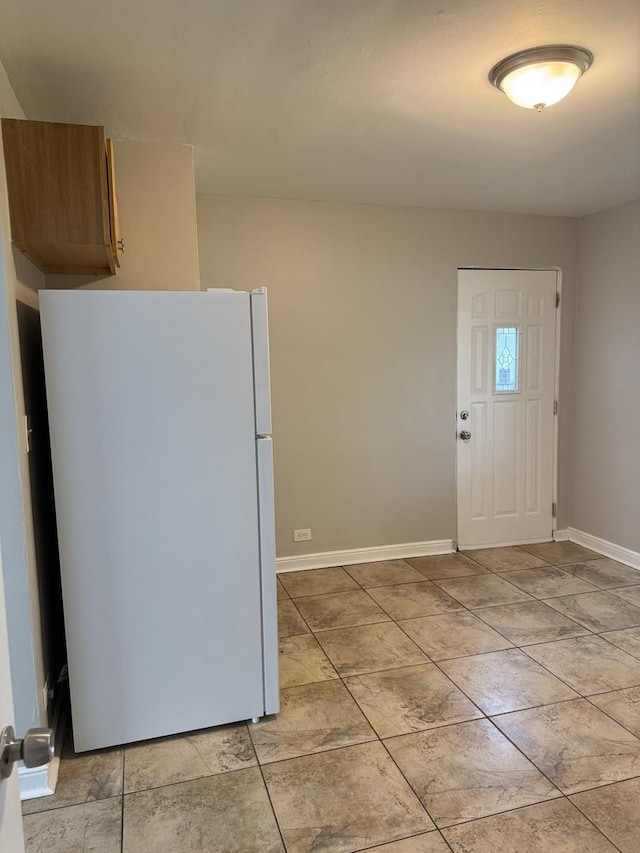 2219 S 13th Ave, Broadview, IL 60155 - kitchen featuring freestanding refrigerator, baseboards, and light tile patterned floors