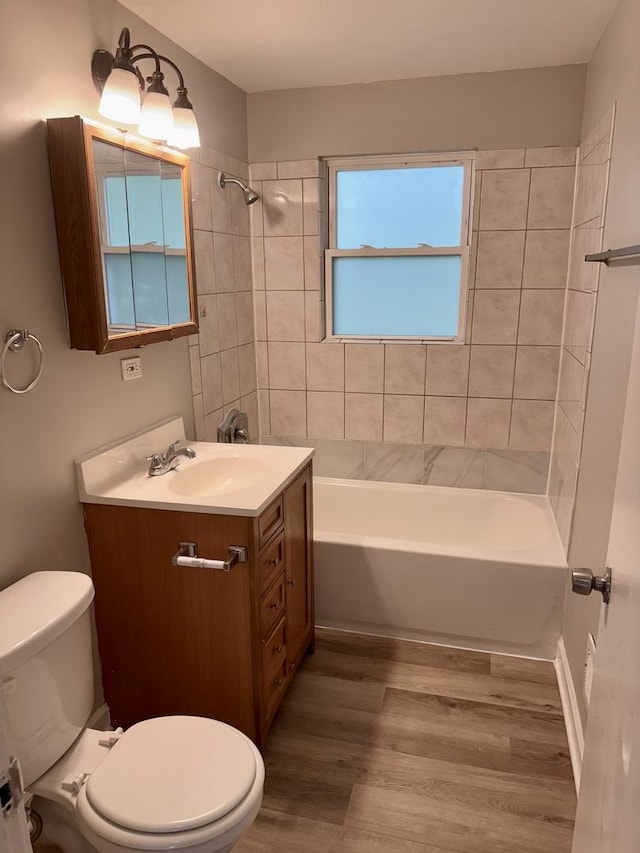 2219 S 13th Ave, Broadview, IL 60155 - full bathroom with toilet, vanity, wood finished floors, and washtub / shower combination