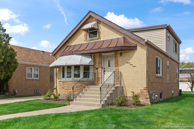 2312 S 1st Ave, North Riverside, IL 60546 - view of front facade featuring a front lawn, brick siding, a standing seam roof, and metal roof