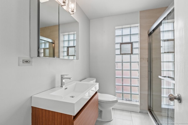 2312 S 1st Ave, North Riverside, IL 60546 - bathroom with toilet, vanity, tile patterned floors, and a shower with door