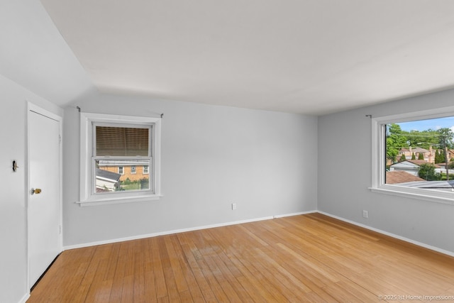 2312 S 1st Ave, North Riverside, IL 60546 - empty room featuring light wood-style flooring, vaulted ceiling, and baseboards