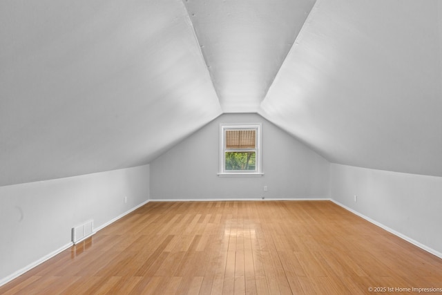 2312 S 1st Ave, North Riverside, IL 60546 - additional living space with vaulted ceiling, light wood-type flooring, and baseboards