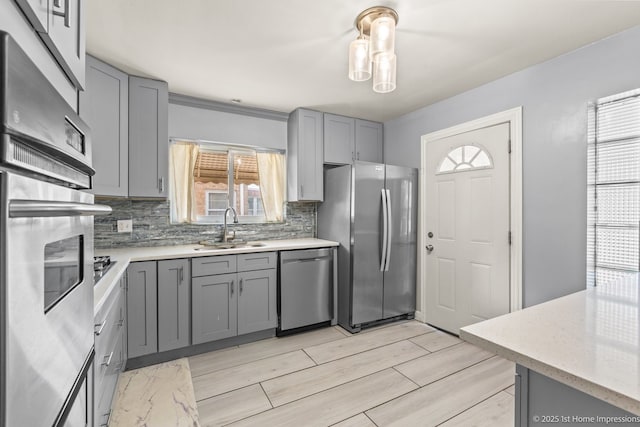2312 S 1st Ave, North Riverside, IL 60546 - kitchen featuring appliances with stainless steel finishes, gray cabinetry, and a sink