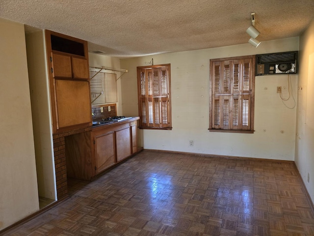 3905 N Oak Park Ave, Chicago, IL 60634 - unfurnished dining area featuring baseboards, a textured ceiling, and a wall unit AC