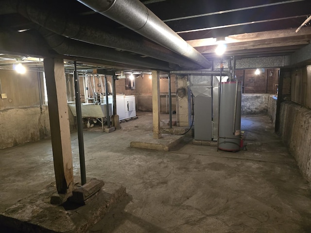3905 N Oak Park Ave, Chicago, IL 60634 - unfinished below grade area with water heater, independent washer and dryer, heating unit, and a sink