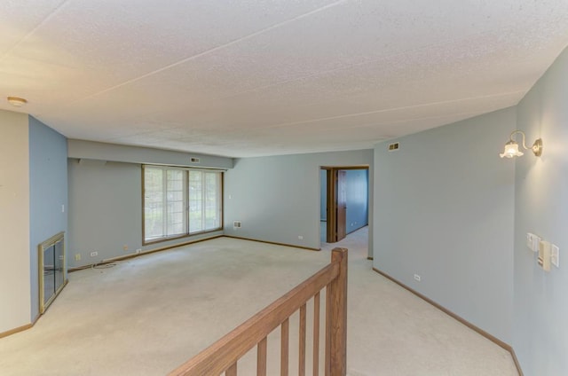 464 S President St Unit 101, Carol Stream, IL 60188 - empty room with carpet floors, a textured ceiling, baseboards, and a smoke detector