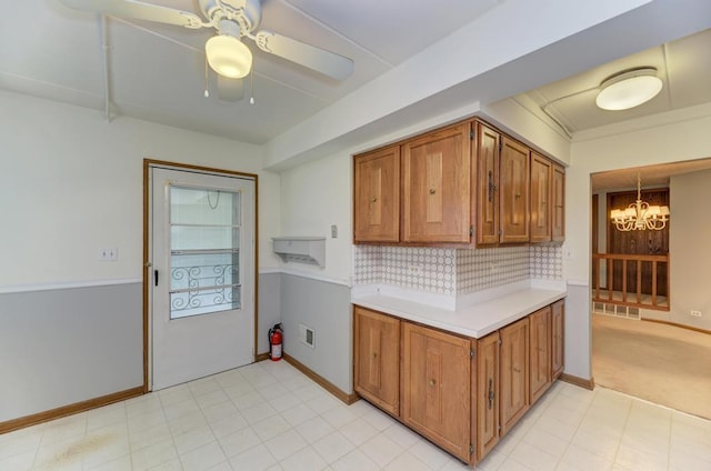 464 S President St Unit 101, Carol Stream, IL 60188 - kitchen with a chandelier, light countertops, brown cabinets, a ceiling fan, and tasteful backsplash
