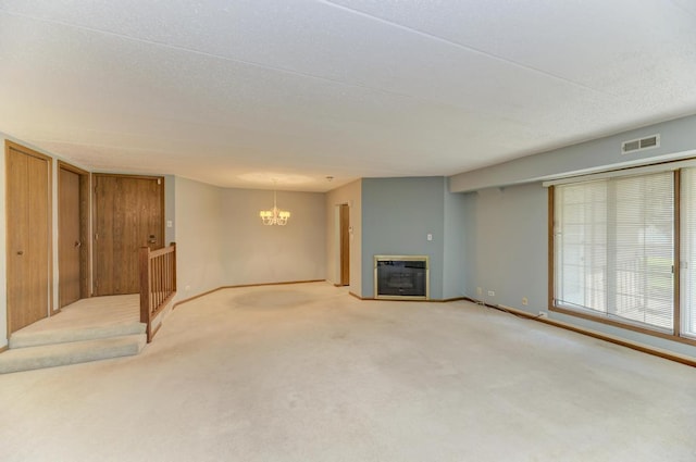 464 S President St Unit 101, Carol Stream, IL 60188 - unfurnished living room with heating unit, a chandelier, carpet floors, a glass covered fireplace, and baseboards