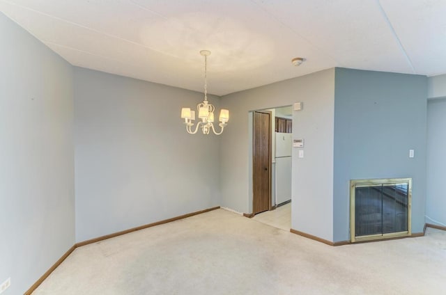 464 S President St Unit 101, Carol Stream, IL 60188 - unfurnished room featuring light colored carpet, a chandelier, baseboards, and a glass covered fireplace