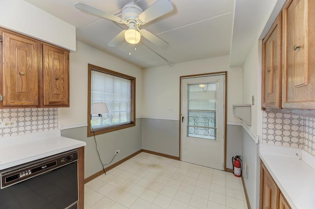 464 S President St Unit 101, Carol Stream, IL 60188 - kitchen with black dishwasher, light countertops, brown cabinets, and decorative backsplash