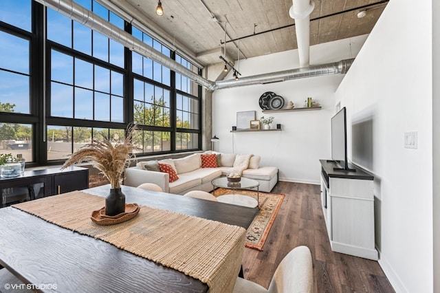 3963 W Belmont Ave Unit 140, Chicago, IL 60618 - dining room with baseboards, a towering ceiling, and wood finished floors