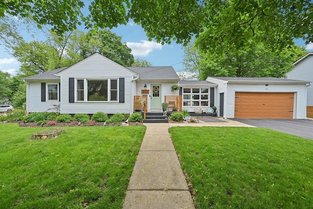 324 W Crystal Lake Ave, Crystal Lake, IL 60014 - view of front facade with driveway, a garage, and a front lawn
