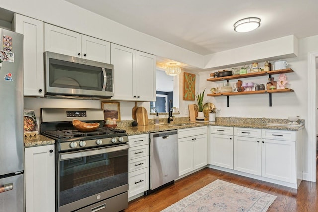 324 W Crystal Lake Ave, Crystal Lake, IL 60014 - kitchen featuring appliances with stainless steel finishes, a sink, white cabinets, dark wood-style floors, and light stone counters