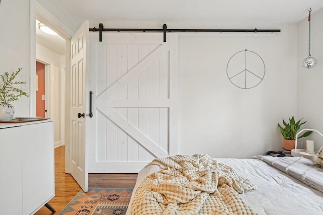 324 W Crystal Lake Ave, Crystal Lake, IL 60014 - bedroom featuring wood finished floors and a barn door