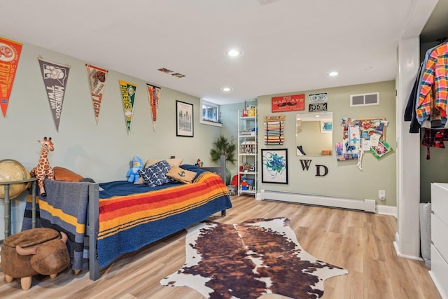 324 W Crystal Lake Ave, Crystal Lake, IL 60014 - bedroom with baseboard heating, wood finished floors, recessed lighting, and baseboards