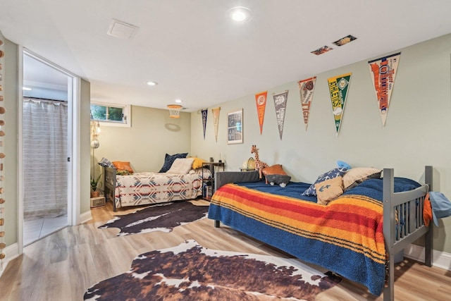 324 W Crystal Lake Ave, Crystal Lake, IL 60014 - bedroom with wood finished floors, baseboards, and recessed lighting